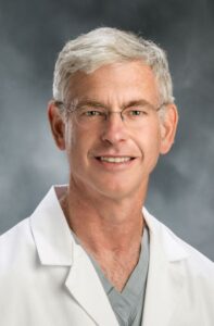 Professional portrait of Dr. Savin, a medical specialist known for expert care and clinical excellence